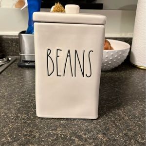 Brand new, never used Rae Dunn large bean canister, white with black writing.